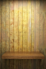 Illuminated empty shelf on wooden wall