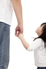 little girl looking her father and holding hand