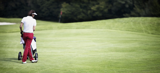 Female golfer standing at green