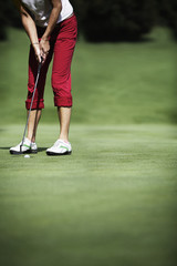 Female golfer putting