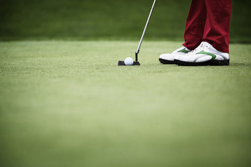 Close-up of golfer putting