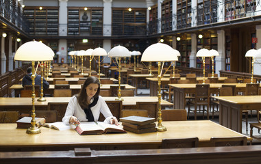 Pretty student studying in library