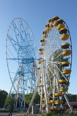 Ferris wheel against a blue sky in the amusement park
