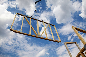 prefabricated framework dangling from a crane