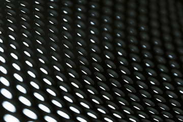 Metal sheet grid background in black.