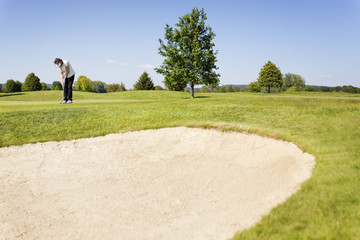 Woman putting in front of bunker.