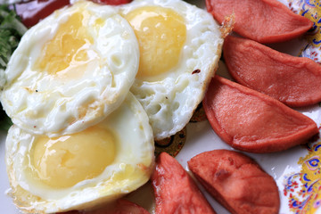 fried eggs with sausages