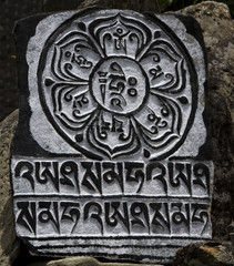 engraved lotus on a mani stone
