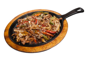 Roasted meat with vegetables on frying pan