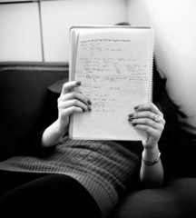 Fototapeta premium young girl reading notes on a couch