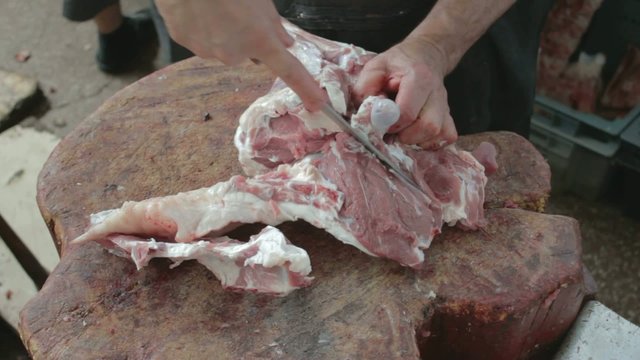 Cutting with knife tendon connecting the tibia on mutton leg