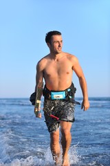 Portrait of a young  kitsurf  man at beach on sunset