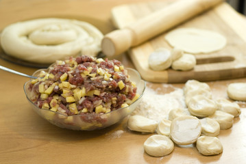 dough with minced meat patties cooking Asian samsa