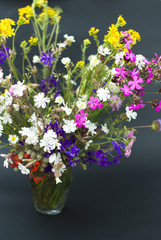 Bouquet of wild flowers on a  black