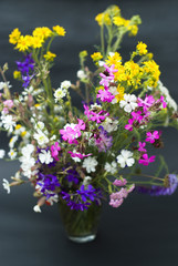 Bouquet of wild flowers on a  black