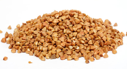 Fototapeta premium Isolated buckwheat on white background. Handful of grain