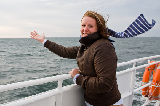 Junge Frau bei Wind auf Schiff