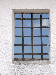 Sky seen through iron bars of window - concept