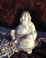 Buddha sitting under leafes
