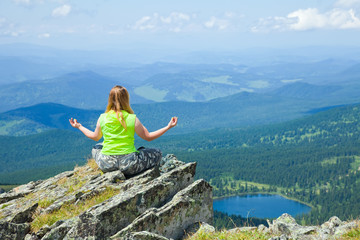 Fototapeta premium Woman meditating on rock
