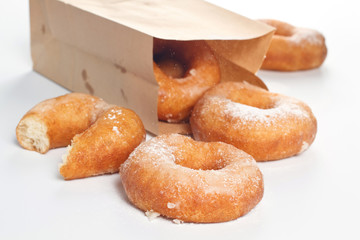 Sweet donuts with powder on white background