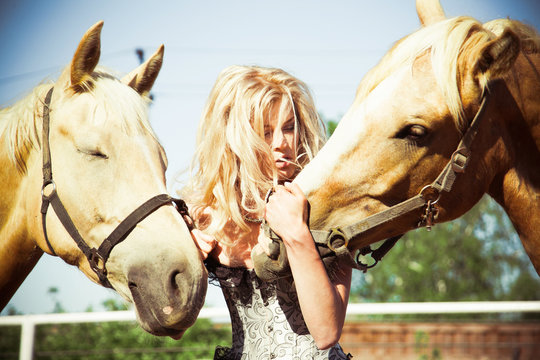 outdoor portrait of young beautiful woman with horse