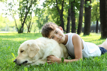 Little boy in the park with a dog