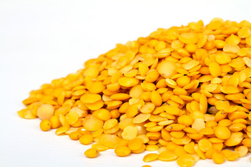 Yellow lentils isolated on white background.Macro shot.