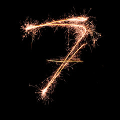 Digit 7 made of sparklers isolated on black