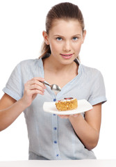 Pretty young woman eating cake. Isolated