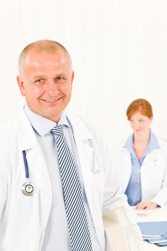 Medical team senior smiling male young woman