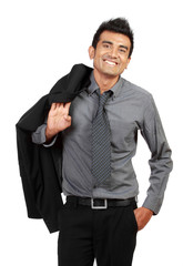 Happy young businessman standing and smiling