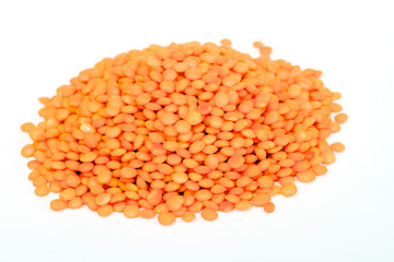 Heap of raw red lentils isolated on white background