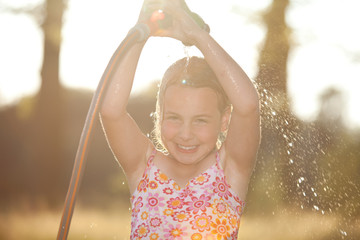 girl takes a shower in the garden, summer