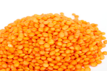 Heap of raw red lentils isolated on white background