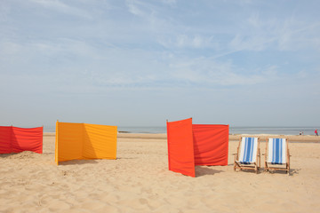 Fototapeta na wymiar Orange and yellow windshields at the beach
