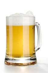 Alcohol light beer mug with froth isolated over white