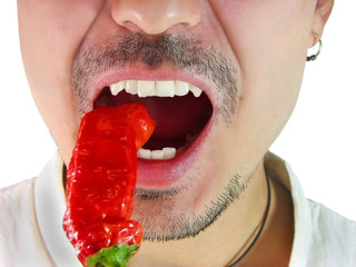 Closeup of man eating red chili hot pepper