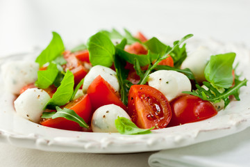 Insalata Caprese with cherry tomatoes and arugula