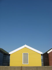 Fototapeta na wymiar Bright yellow beach hut on an English beach