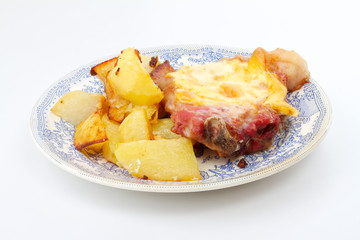 Grilled steak meat with cheese sauce and potatoes