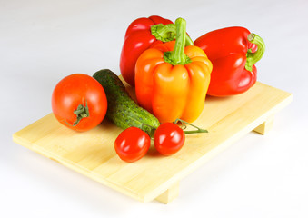 fresh and juicy vegetables on the wood plate isolated