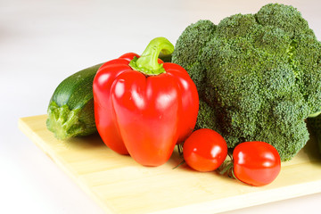 fresh and juicy vegetables on the wood plate isolated