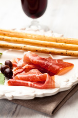 Spanish serrano ham with olives and grissini