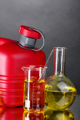 canister and fuel in test tubes on gray background