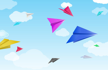 colorful paper planes on sky and cloud background