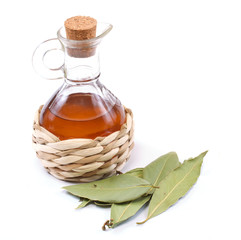vinegar bottle and laurel leaf on the white
