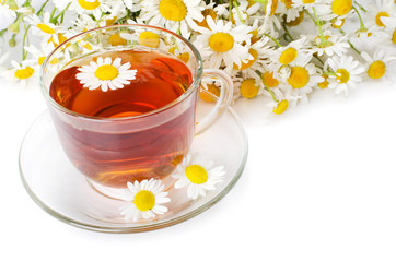 Glass cup with a camomile tea