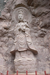 Buddha statue on the rock cliff