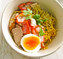 dry noodle with boiled eggs and pork in bowl